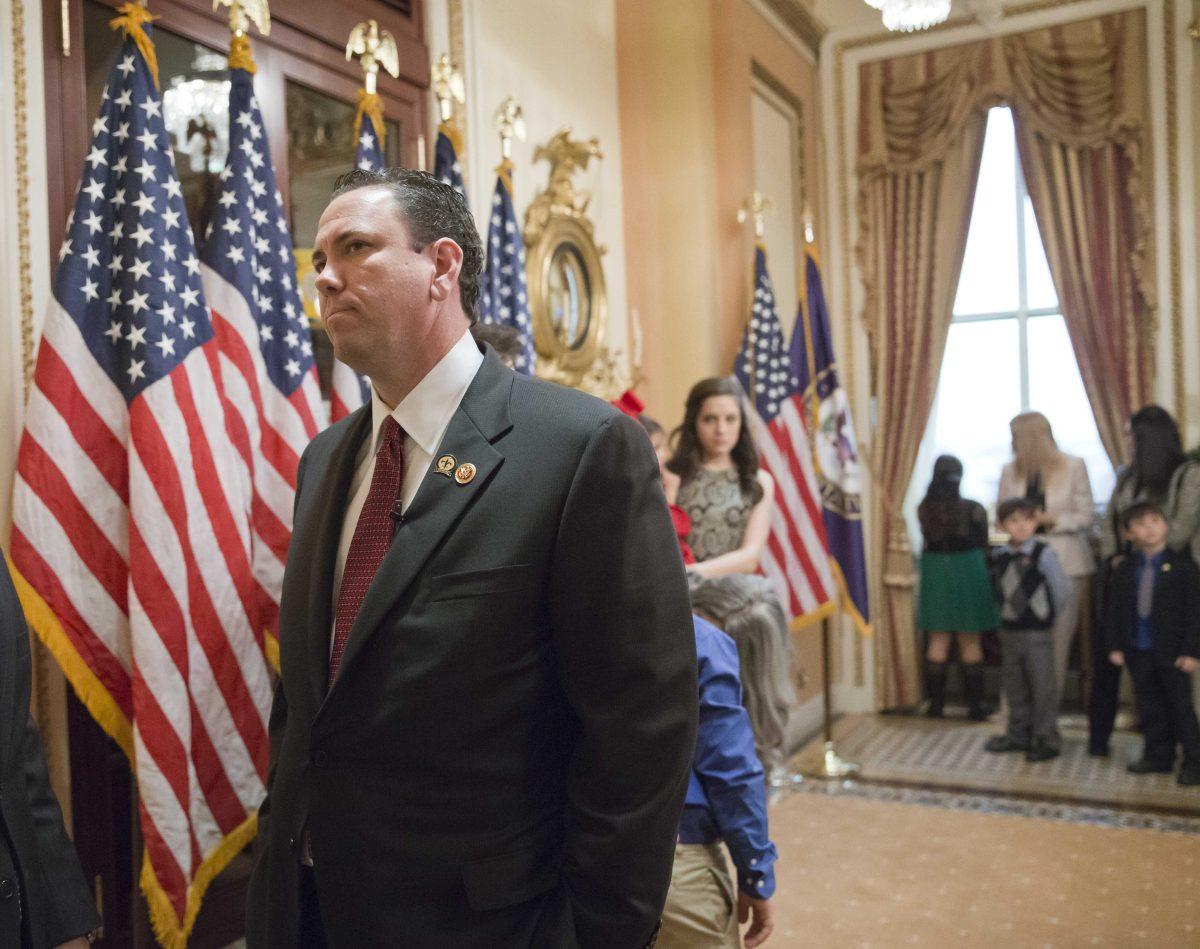 This photo taken Nov. 21, 2013 shows then-newly-elected Rep. Vance McAllister, R-La. waiting to be sworn in on Capitol Hill in Washington. McAllister says he's asking his family and constituents for forgiveness after a West Monroe newspaper published a video that it says shows the congressman kissing a female staffer in his congressional office in Monroe, La. McAllister, only in office a little over four months, attracted national attention because of his endorsement from the bearded men of the "Duck Dynasty" reality TV show. (AP Photo/J. Scott Applewhite)