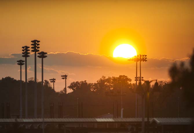 The sun sets behind Alex Box Stadium on Tuesday, April 22, 2014.