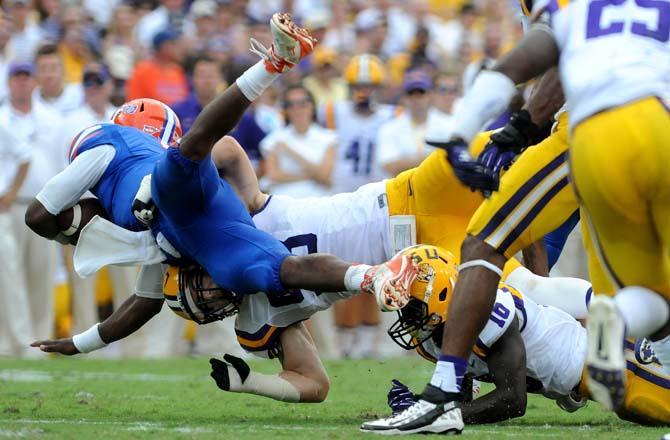 LSU junior defensive end Jordan Allen (98) sacks Florida quarterback Tyler Murphy (3) Saturday, October 12, 2013 during the Tigers' 17-6 victory against Florida in Tiger Stadium.