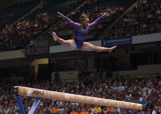 LSU junior all-around gymnast Lloimincia Hall jumps on the beam Saturday, April 19, 2014 during the second rotation of the NCAA Super Six Finals in Birmingham, Ala.