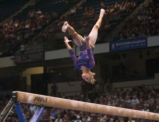 LSU senior all-around gymnast Kaleigh Dickson flips on the beam Saturday, April 19, 2014 during the second rotation of the NCAA Super Six Finals in Birmingham, Ala.