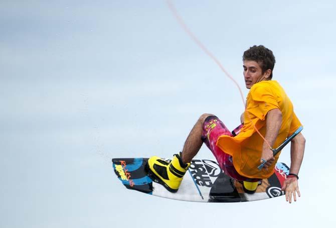 LSU wakeboarder Nick Vaccari passes the handle behind his back Wednesday, April 30, 2014, in the Gulf Intracoastal Waterway.