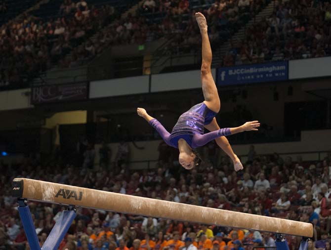 LSU junior all-around gymnast Rheagan Courville flips on the beam Saturday, April 19, 2014 during the second rotation of the NCAA Super Six Finals in Birmingham, Ala.