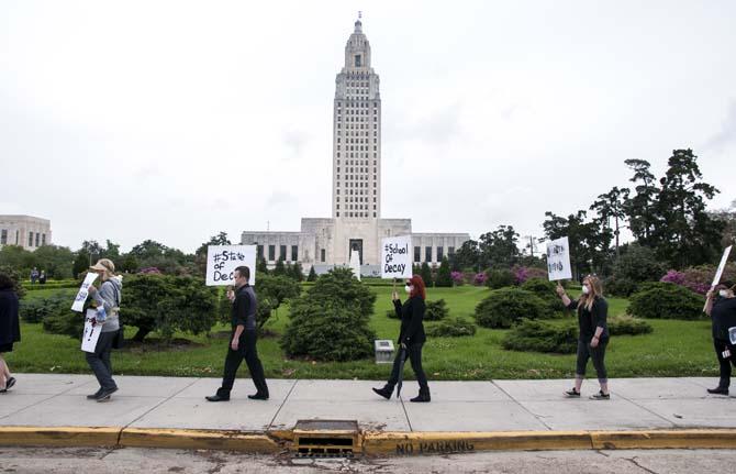 LSU School of Art &amp; Design students and supporters hold up signs in protest of the poor conditions in the Studio Arts Building on Tuesday, April 8, 2014, in front of the Louisiana State Capitol.