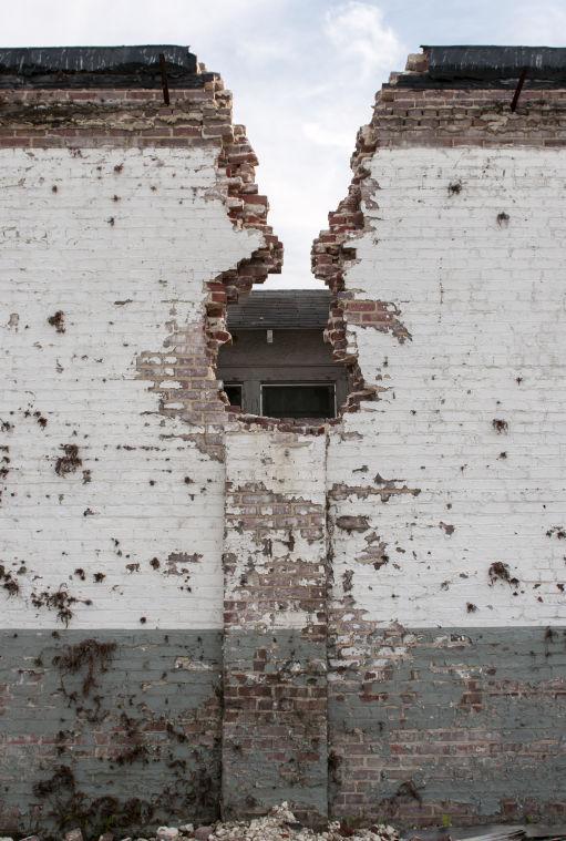 A crumbling brick wall stands against a house Wednesday, April 2, 2014, in Old South Baton Rouge.