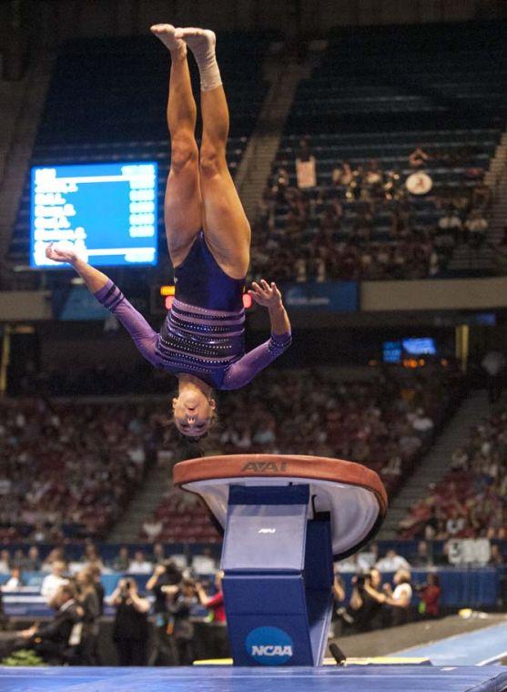 LSU junior all-around gymnast Rheagan Courville flips off the vault Saturday, April 19, 2014 in the fifth rotation of the NCAA Super Six Finals in Birmingham, Ala.