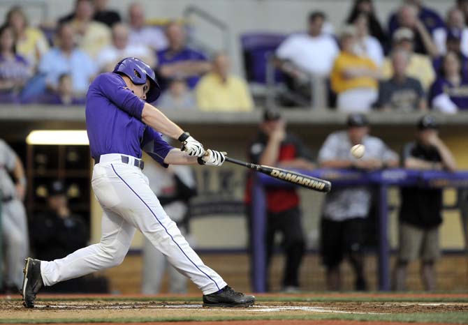 LSU senior outfielder Sean McMullen (7) hits a triple Saturday, March 22, 2014, during the Tigers' 2-1 win against Georgia in Alex Box Stadium.