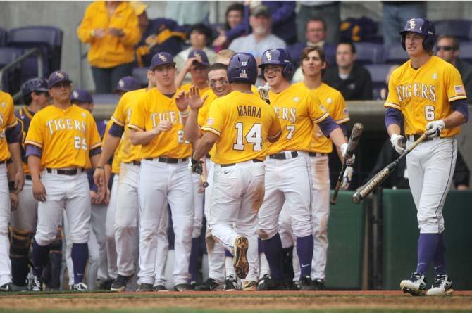 LSU senior infielder Chistian Ibarra (14) is congradulated at home-plate after a homerun Sunday, April 6, 2014 during the Tigers' 17-4 victory against Mississippi State at Alex Box Stadium.