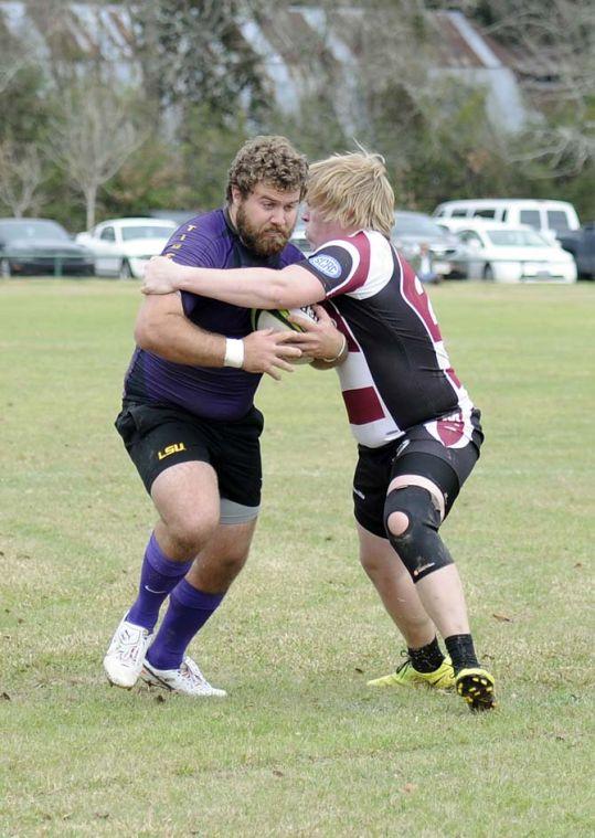 A Mississippi State defender tries to tackle LSU hooker Mackie Hirsch (2) on Saturday, Feb. 22, 2014 during the Tigers' 75-5 win against the Bulldogs at Highland Road Community Park.