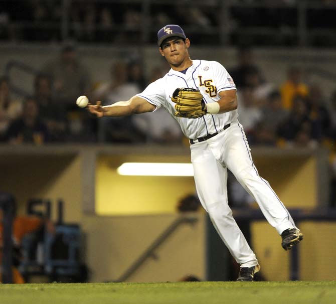 LSU senior infielder Christian Ibarra (14) throws to first for an out Friday, April 25, 2014 during the Tigers' 8-7 victory against Tennessee at Alex Box Stadium.