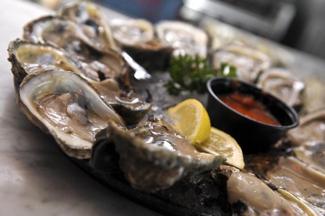 A dozen of raw oysters is prepared Wednesday, Oct. 24, 2012, at Acme Oyster House.