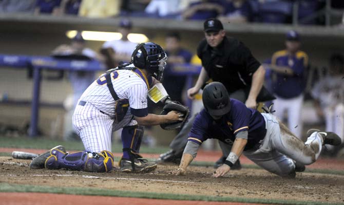 Alcorn senior Brandon Ollet (9) is struck out by LSU sophomore catcher Chris Chinea (26) on Tuesday, April 29, 2014, during the Tigers' 9-7 victory against Alcorn in Alex Box Stadium.