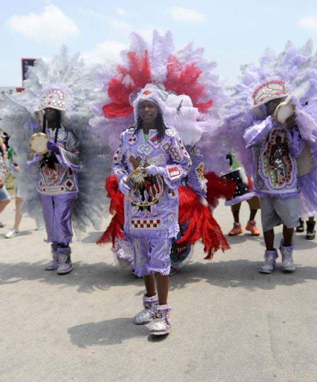 A group of Mardi Gras Indians walks around Saturday, April 26, 2014, during the New Orleans Jazz and Heratige Festival in New Orleans.