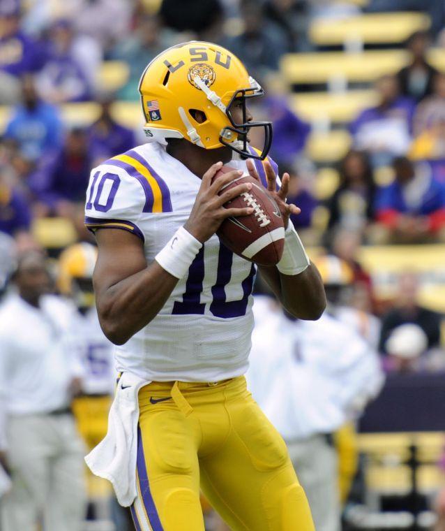 Sophomore quarterback Anthony Jennings (10) searches for a receiver Saturday, April 5, 2014 during the white squad's 42-14 victory against the purple squad in the National L Club Spring Game in Tiger Stadium.