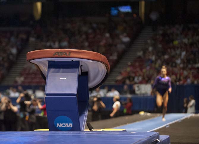 LSU junior all-around gymnast Rheagan Courville runs toward the vault Saturday, April 19, 2014 in the fifth rotation of the NCAA Super Six Finals in Birmingham, Ala.