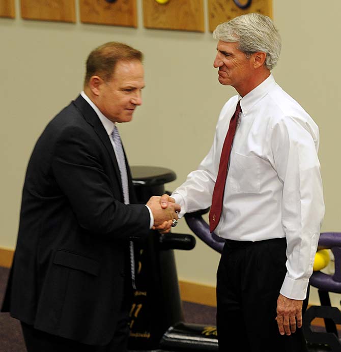 LSU head coach Les Miles and LSU Athletic Director Joe Alleva shake hands Wednesday in the Football Operations Building. One day after reports said Miles received a contract offer from the University of Arkansas, Alleva announced that Miles signed a 7-year contract to stay as LSU's football coach.&#160;