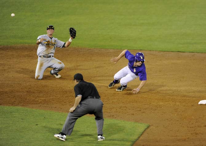 LSU sophomore infielder Alex Bregman (8) tries to avoid a percieved tag and dives back toward second base Tuesday, April 22, 2014, during the Tigers' 6-0 win against Tulane in Alex Box Stadium.