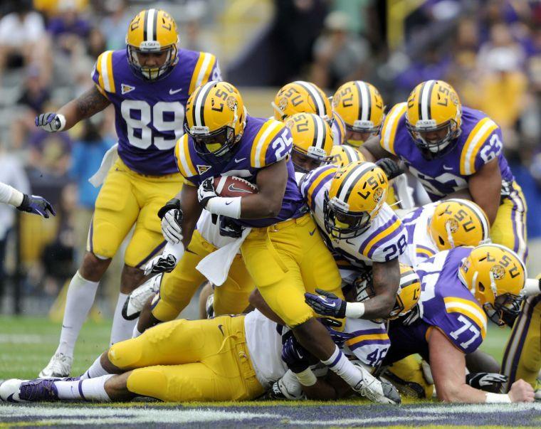 LSU freshman runningback Reshaud Henry (25) gets tackled Saturday, April 5, 2014 during the white squad's 42-14 victory against the purple squad in the National L Club Spring Game in Tiger Stadium.