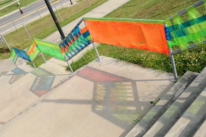 The sun reflects colorful designs on the ground Tuesday, April 29, 2014 on the levee.