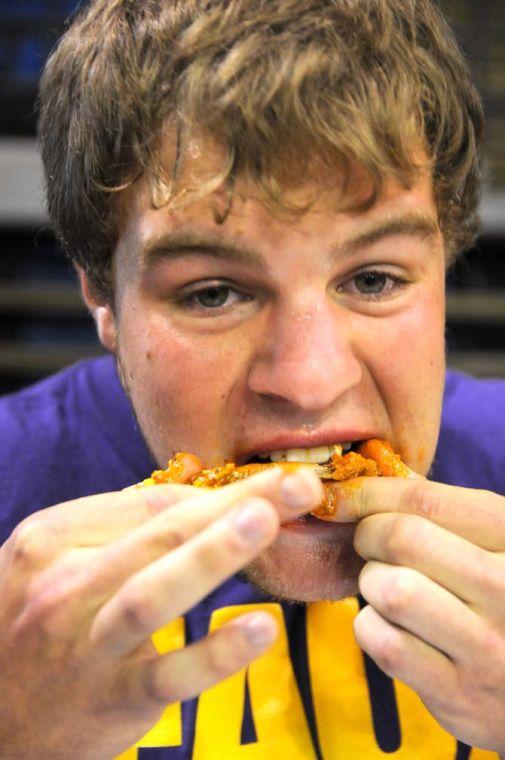 Contestant Andrew Badeaux bites into a wing during a hot wing eating contest Saturday, April 26, 2014 during the first annual Louisiana Wing-a-thon at the Baton Rouge River Center.