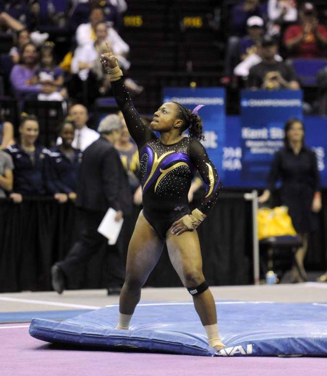 LSU junior all-around Lloimincia Hall points to the sky Saturday, April 5, 2014, during an NCAA Gymnastics Regional meet in the PMAC. The Tigers won the met with a school-record score of 198.325.