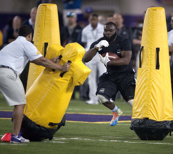 LSU senior full back J.C. Copeland (44) runs through the running back drill on Wednesday, April 9, 2014 during LSU Pro Day in the LSU Indoor Practice Facility.