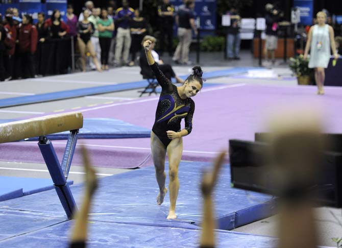 LSU junior all-around Rheagan Courville celebrates after her beam routine Saturday, April 4, 2014, during the NCAA Gymnastics Regional in the PMAC. The Tigers won the meet with a school-record 198.325.