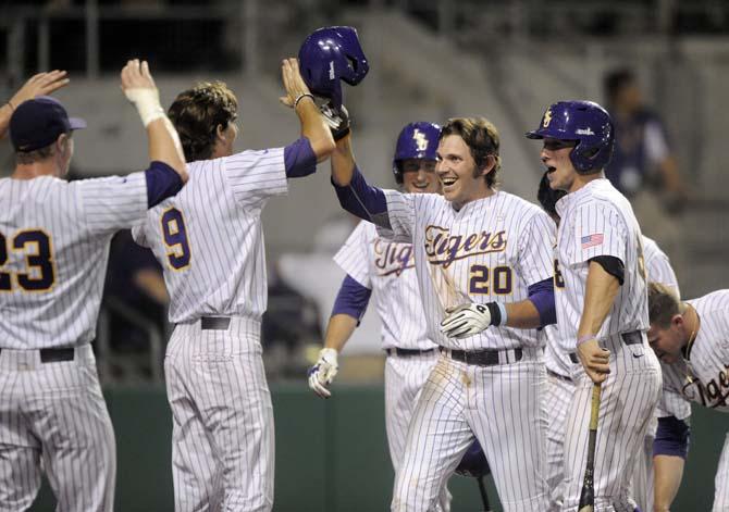 LSU junior infielder Conner Hale (20) celebrates with his teammates after scoring a homerun Tuesday, April 29, 2014, during the Tigers' 9-7 victory against Alcorn in Alex Box Stadium.