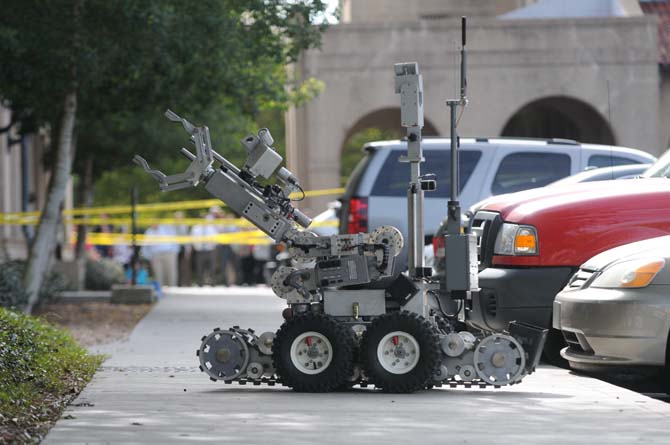 A robot from the Baton Rouge City Police Bomb Squad is sent out to examine the suspicious packages Monday, April 7, 2014 near Thomas D. Boyd Hall.