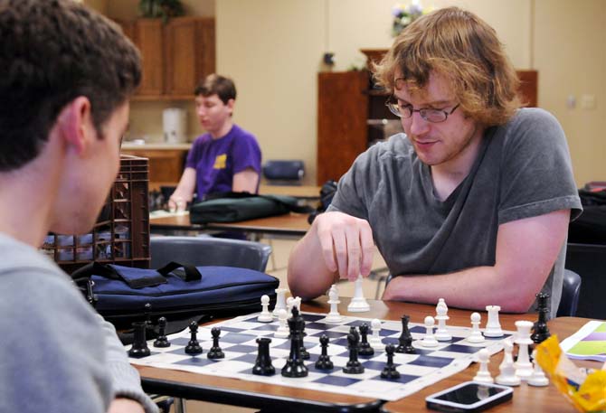 Electrical engineering senior Charles Bryan moves the king piece Tuesday, April 22, 2014 during chess practice in Peabody Hall.