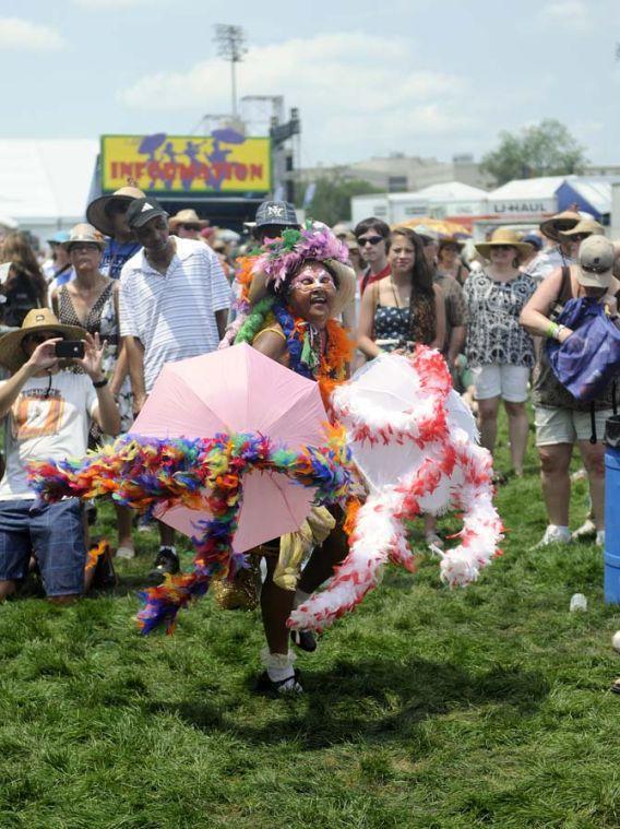 A festival attendee dances in front of the Fais Do-Do stage Saturday, April 26, 2014, during the 2014 New Orleans Jazz and Heratige Festival in New Orleans.