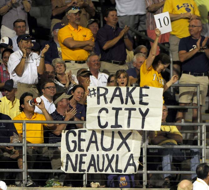 LSU fans display signs Friday, April 25, 2014 during the Tigers' 8-7 victory against Tennessee at Alex Box Stadium.