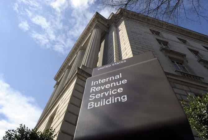 FILE - This March 22, 2013, file photo shows the exterior of the Internal Revenue Service building in Washington. Struggling to figure out your federal tax return? You're not alone, but you're in the minority. With the tax filing deadline looming on April 15, a majority of Americans say completing a federal tax return is easy, according to a new Associated Press-GfK poll.(AP Photo/Susan Walsh, File)