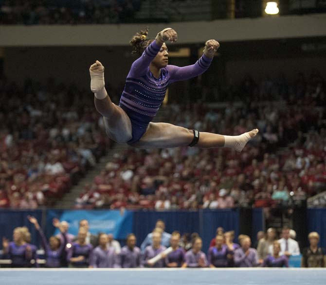 LSU junior all-around gymnast Lloimincia Hall jumps during her floor routine Saturday, April 19, 2014 in the fourth rotation of the NCAA Super Six Finals in Birmingham, Ala.