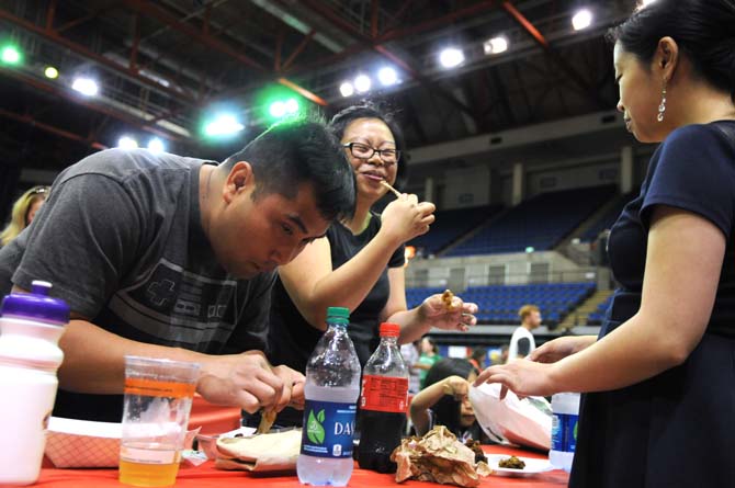 Event attendees enjoy wings together Saturday, April 26, 2014 during the first annual Louisiana Wing-a-thon at the Baton Rouge River Center.