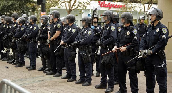 Oakland police officers in riot gear line Frank H. Ogawa plaza Tuesday, Oct. 25, 2011, in Oakland, Calif. Occupy Oakland protestors were evicted from the plaza early this morning. Police in riot gear began clearing anti-Wall Street protesters on Tuesday morning from the plaza in front of Oakland's City Hall where they have been camped out for about two weeks. City officials had originally been supportive of the protesters, but the city later warned the protesters that they were breaking the law and could not stay in the encampment overnight. (AP Photo/Ben Margot)