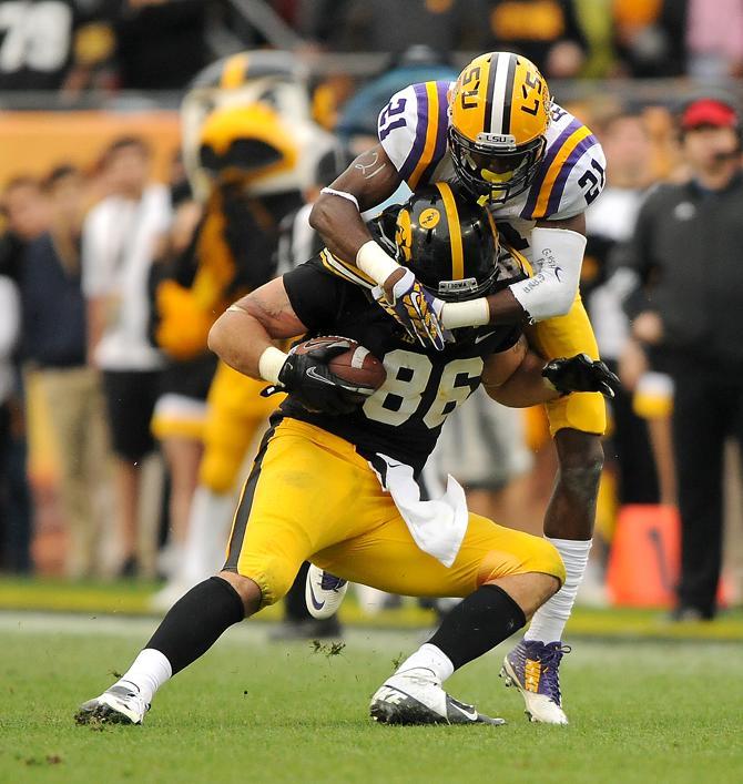 LSU freshman defensive back Rashard Robinson (21) tackles Iowa tightend C.J. Fiedorowicz (86) on Wednesday, Jan. 1, 2014 during the Tigers' 21-14 victory against the Iowa Hawkeyes in the Outback Bowl at Raymond James Stadium in Tampa, Florida.