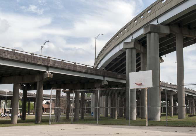 A basketball court sits between interstate ramps Wednesday, April 2, 2014, near Thomas H. Delpit Drive.