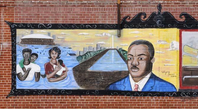 A mural of Hurricane Katrina and Martin Luther King Jr. covers the walls of an abandoned building on Thomas Delpit Drive in Old South Baton Rouge.