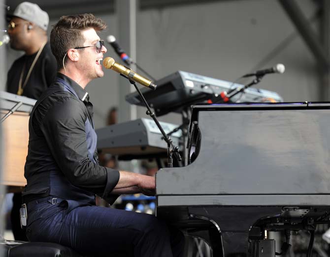 Robin Thicke plays the piano Saturday, April 26, 2014, during the 2014 New Orleans Jazz and Heratige Fesitval in New Orleans.