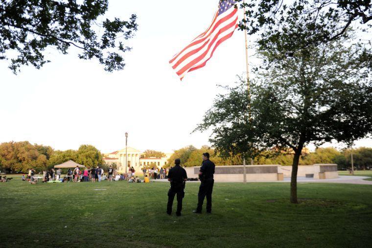 Police officers watch as students gather for the Spring Greening Legalize Marijuana Festival on April 24, 2014 at the LSU Parade Grounds.