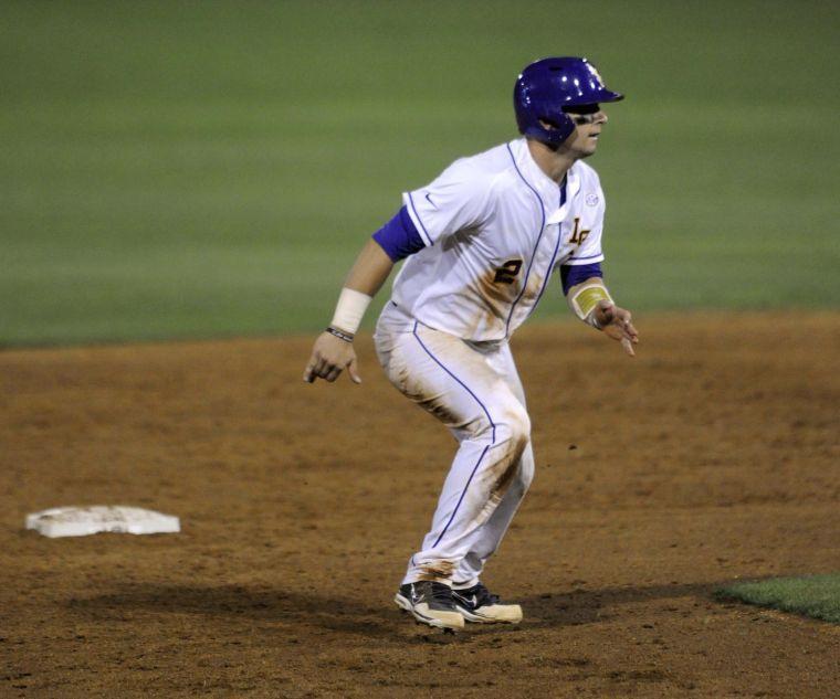 LSU junior infielder and catcher Tyler Moore (2) steals a base during the Tigers' 3-0 victory against Mississippi State on Friday, April 4, 2014 at Alex Box Stadium.