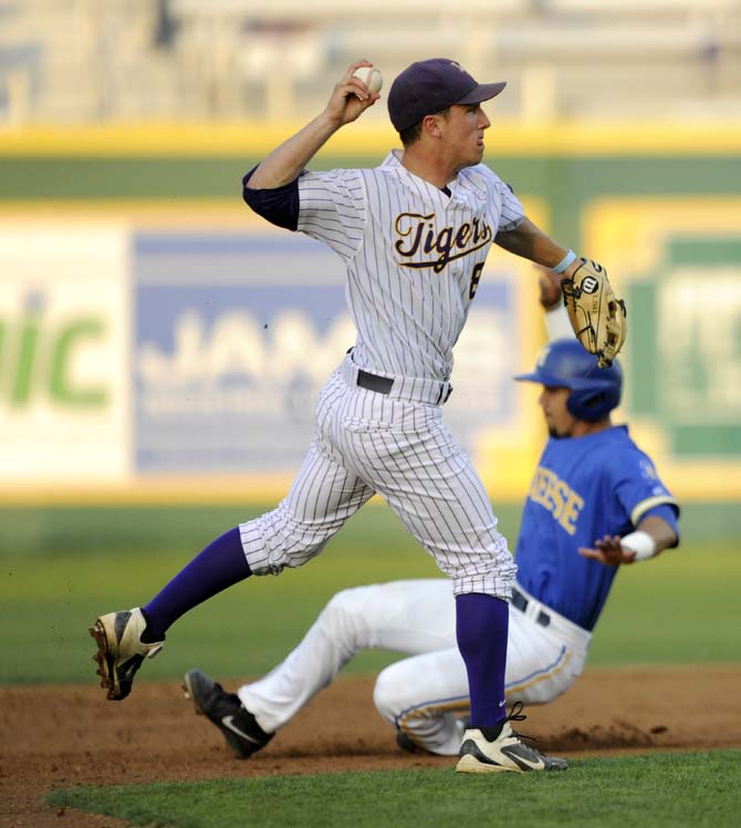 LSU sophomore infielder Alex Bregman (8) throws the ball to first base Wednesday, April 2, 2014, during the Tigers' 10-3 victory against McNeese in Alex Box Stadium.