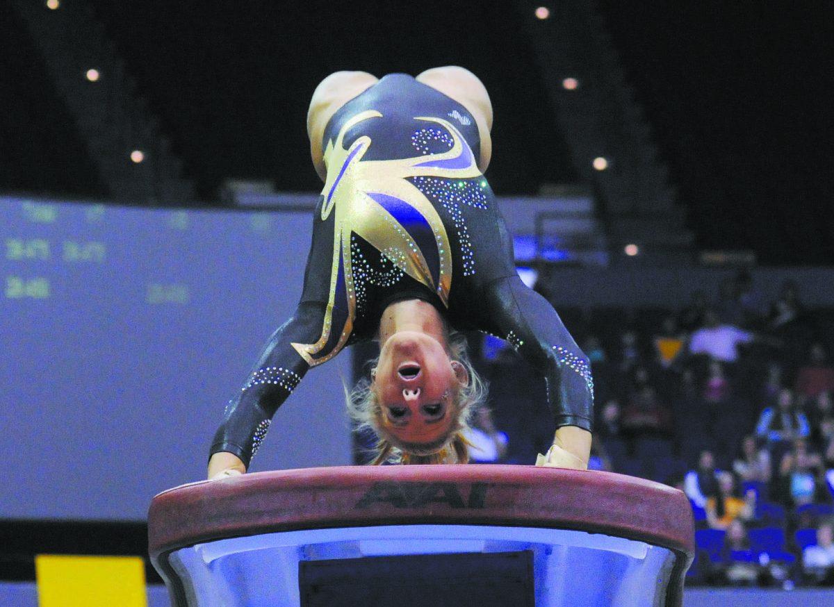 LSU senior Sarie Morrison attempts a vault Friday, March 14, 2014 during the Lady Tigers' 197.800-195.000 victory against Kentucky in the PMAC.