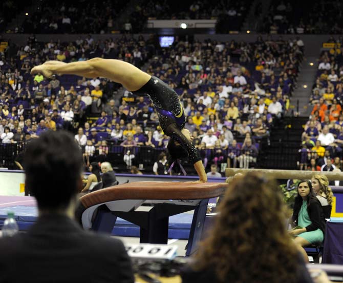 LSU junior all-around Rheagan Courville vaults Saturday, April 5, 2014, during an NCAA Gymnastics Regional meet in the PMAC. The Tigers won the meet with a school-record score of 198.325.