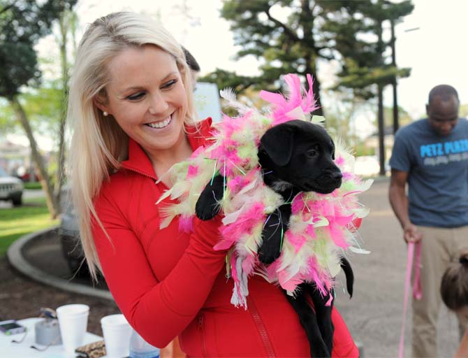 Elizabeth Barkley Hammett holds an adoptable puppy Monday, April 7, 2014 at the Woofstock event at Petz Plaza on Jefferson Highway.