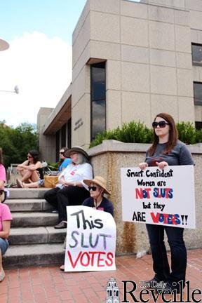 Kacey Edgar, McNeese State University history senior, holds a sign supporting women&#8217;s rights Saturday afternoon during the Unite Women&#8217;s Rally at City Hall Plaza.