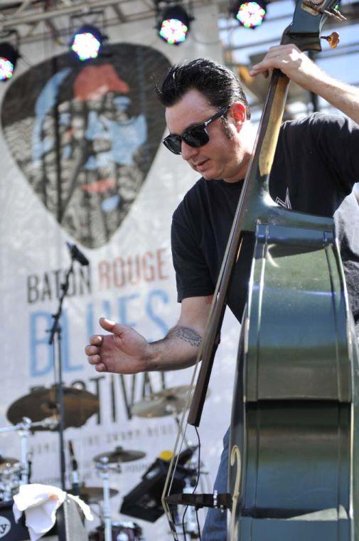 A member of the band C.C. Adcock &amp; The Lafayette Marquis strums his upright bass on the Galvez Stage on Saturday, April 13, 2013 during the Baton Rouge Blues Festival in North Boulevard Town Square downtown.