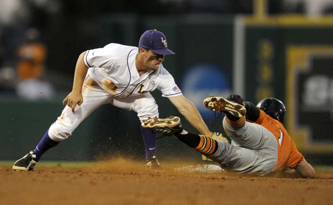 LSU sophomore infielder Alex Bregman (8) catches Tennessee junior infielder Will Maddox attempting to steal second Friday, April 25, 2014 during the Tigers' 8-7 victory against Tennessee at Alex Box Stadium.