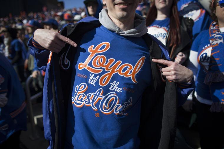 A New York Mets fan shows off his shirt that reads "Loyal 'til the Last Out" during a baseball game against the Washington Nationals on opening day at Citi Field, Monday, March 31, 2014, in New York. (AP Photo/John Minchillo)